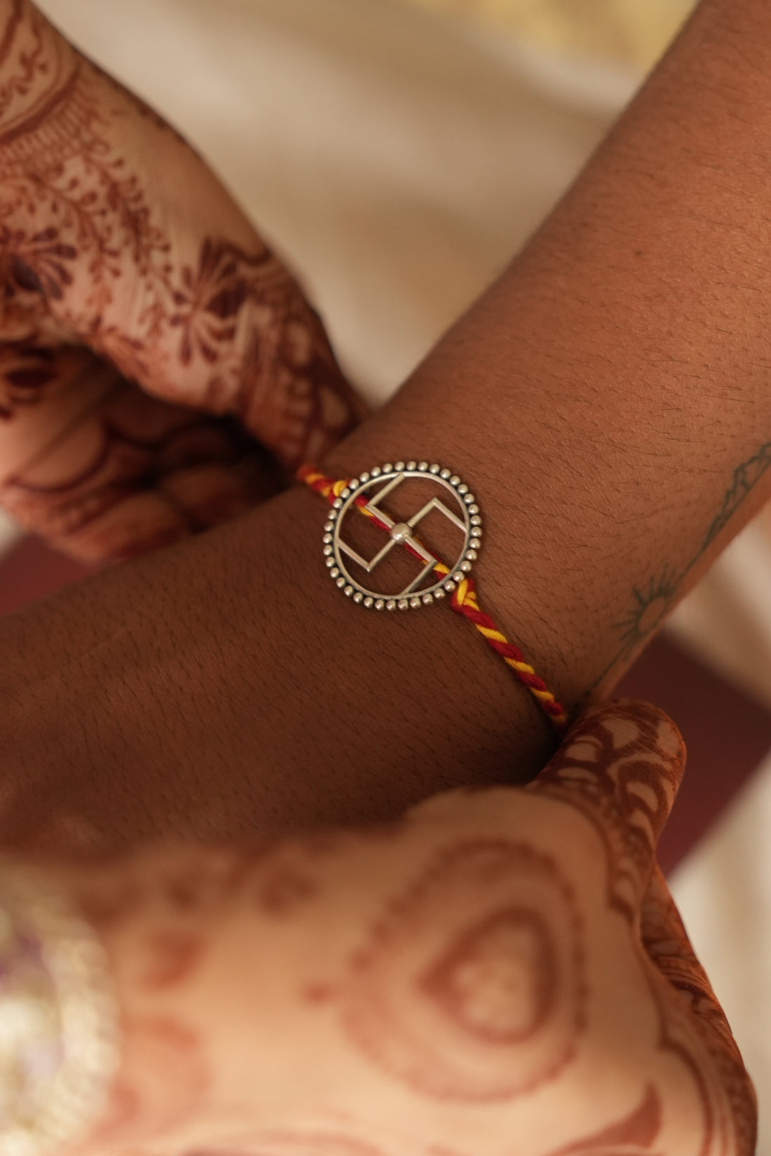 silver swastik rakhi 